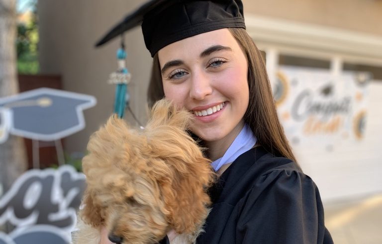 Girl Celebrating Graduation Day with Her Dog